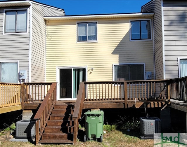 rear view of house with a deck and central AC