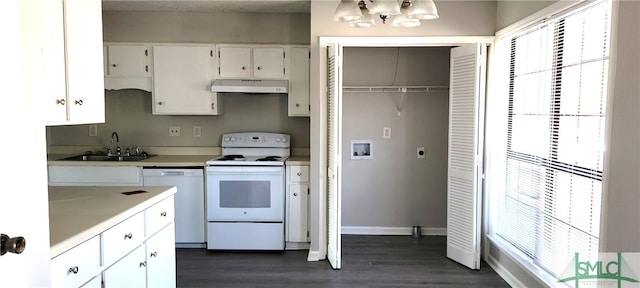 kitchen with sink, white cabinets, dark hardwood / wood-style flooring, white appliances, and a notable chandelier