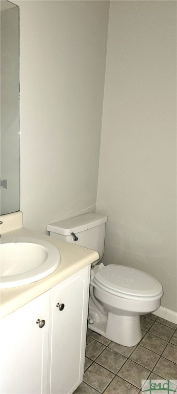 bathroom featuring tile patterned floors, vanity, and toilet