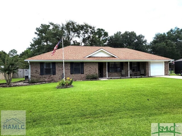 ranch-style house with a garage and a front yard