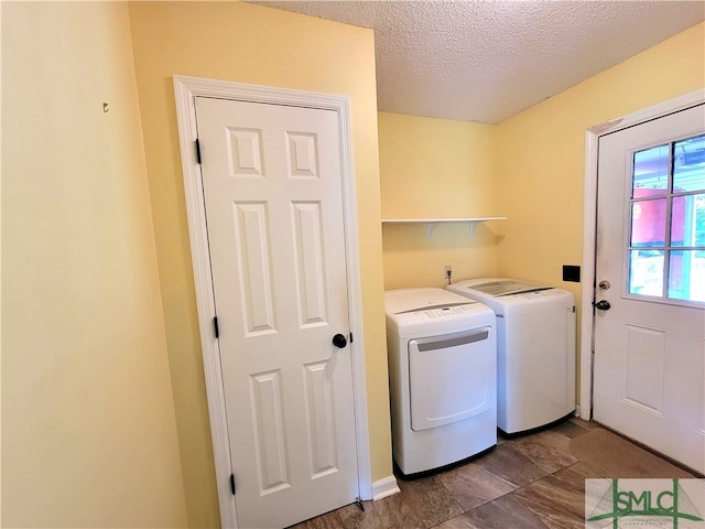 laundry area featuring washer and clothes dryer and a textured ceiling