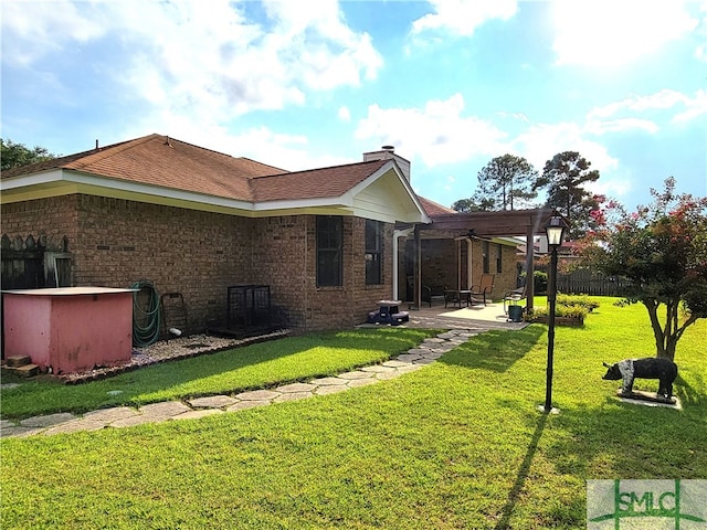 rear view of property with a patio area and a yard