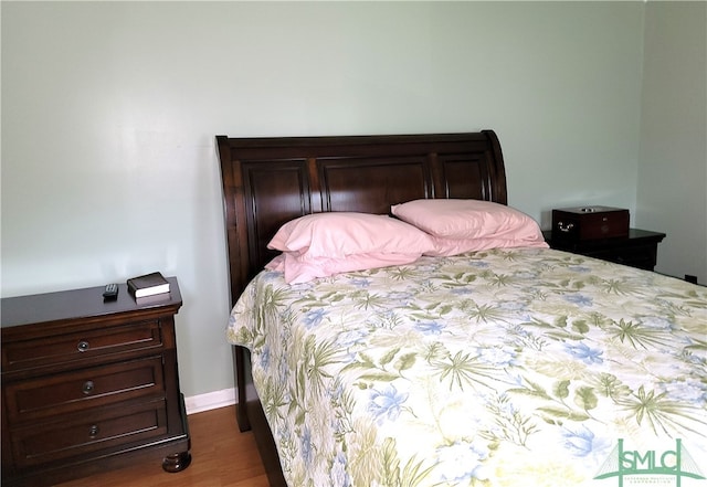 bedroom with dark hardwood / wood-style flooring