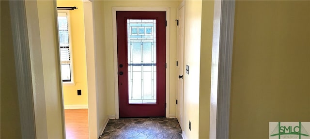 doorway to outside with dark hardwood / wood-style flooring and plenty of natural light