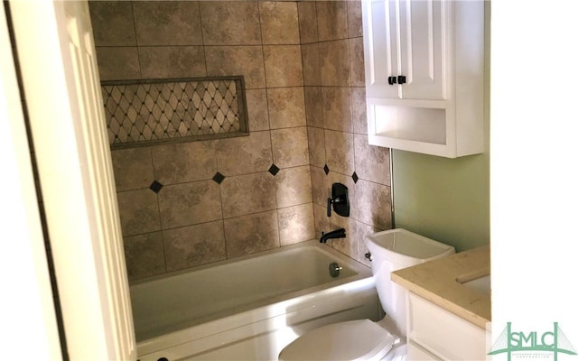 full bathroom with vanity, toilet, and tiled shower / bath