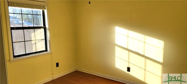 unfurnished room featuring dark hardwood / wood-style flooring