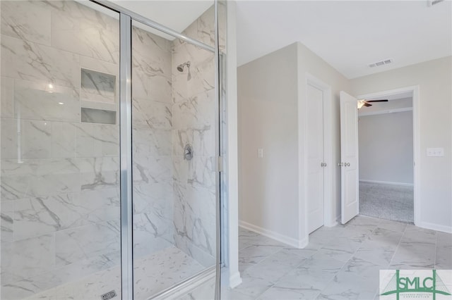 bathroom featuring ceiling fan and an enclosed shower