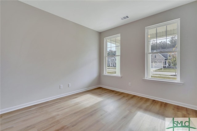 unfurnished room with a wealth of natural light and light wood-type flooring