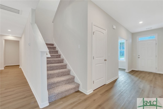 foyer entrance with light hardwood / wood-style floors