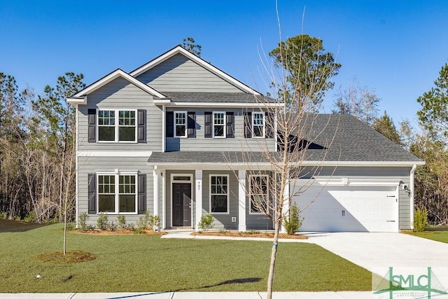 view of front of home featuring a front lawn and a garage