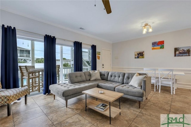 living room featuring ceiling fan, light tile patterned flooring, and crown molding