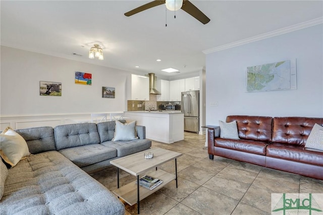 tiled living room featuring ceiling fan and crown molding