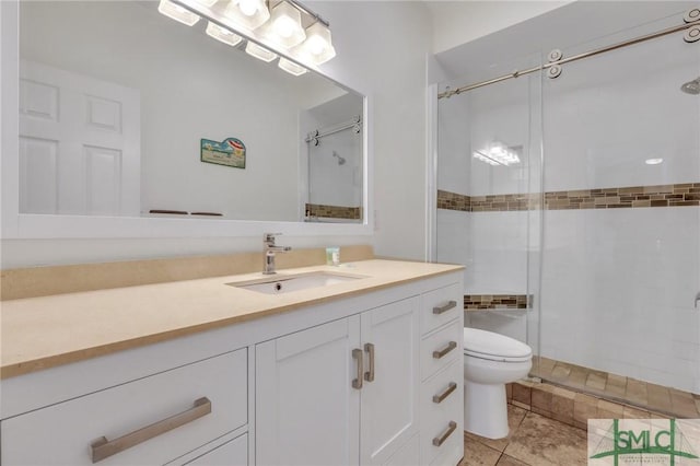 bathroom with tile patterned floors, a tile shower, vanity, and toilet