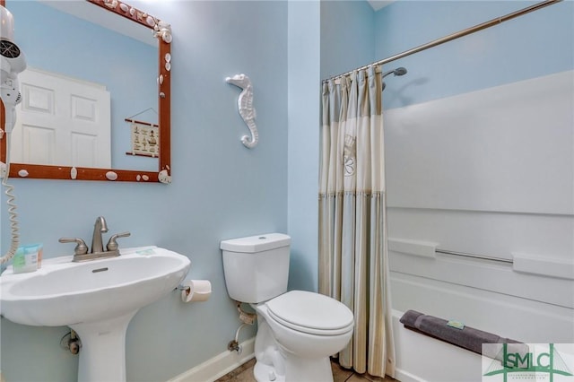 full bathroom featuring shower / bath combination with curtain, sink, and toilet