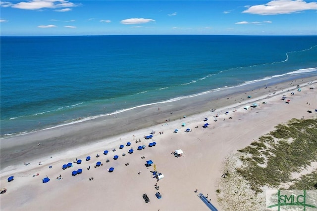 birds eye view of property with a water view and a view of the beach