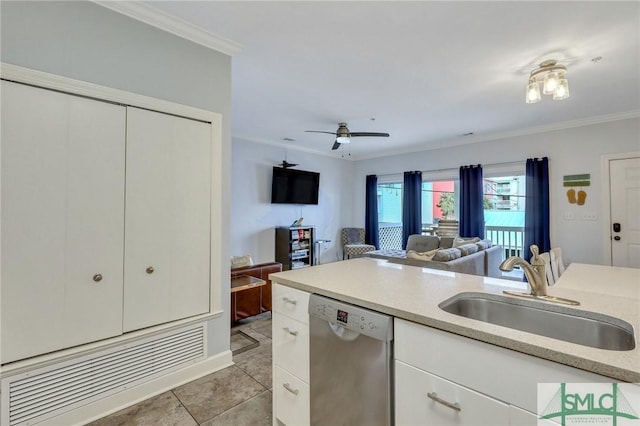 kitchen with light tile patterned floors, sink, dishwasher, crown molding, and white cabinets