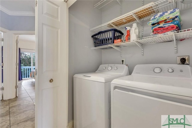 clothes washing area with ornamental molding, light tile patterned flooring, and washer and clothes dryer