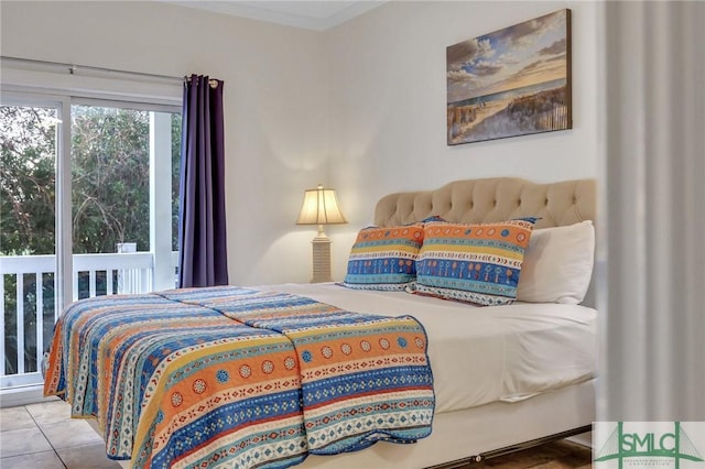 tiled bedroom featuring crown molding and access to outside