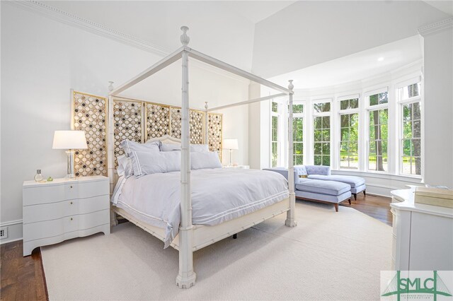 bedroom with wood-type flooring and ornamental molding