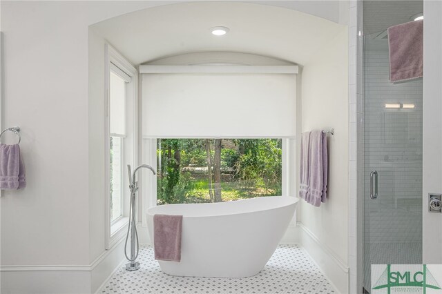 bathroom with tile patterned floors and plus walk in shower