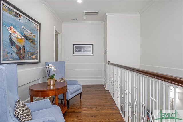 living area with dark hardwood / wood-style flooring and crown molding