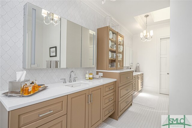 bathroom with decorative backsplash, crown molding, vanity, and an inviting chandelier