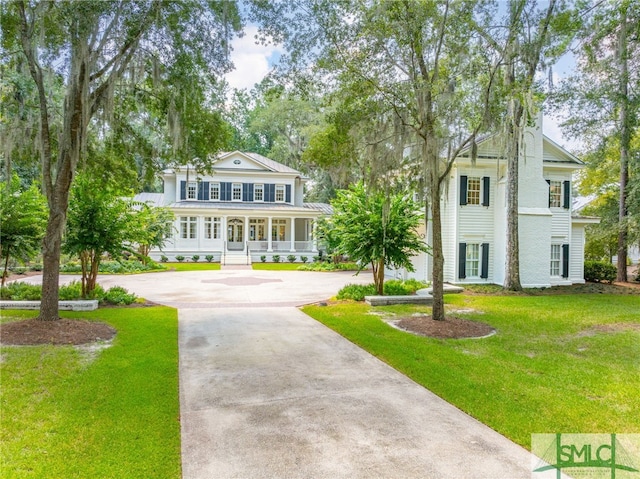 neoclassical / greek revival house featuring covered porch and a front lawn