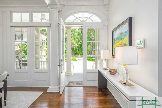 doorway to outside with ornate columns, plenty of natural light, and dark hardwood / wood-style floors