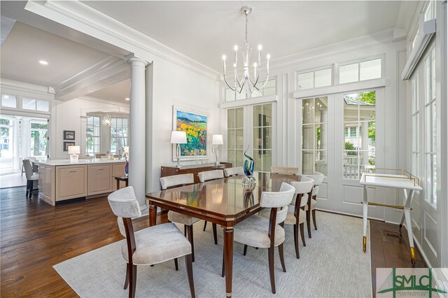 dining space featuring french doors, dark hardwood / wood-style flooring, an inviting chandelier, and plenty of natural light