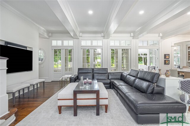 living room with beam ceiling, crown molding, dark hardwood / wood-style flooring, and plenty of natural light