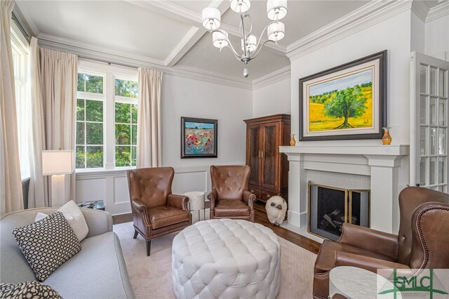 sitting room featuring beam ceiling, light hardwood / wood-style flooring, a notable chandelier, and ornamental molding