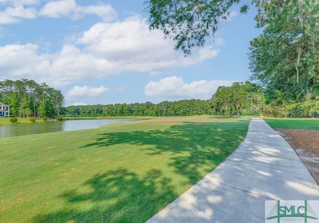 view of home's community featuring a water view and a yard