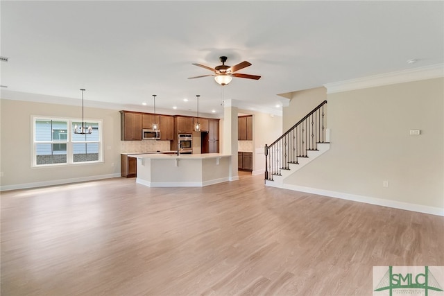 unfurnished living room featuring light hardwood / wood-style floors, ceiling fan with notable chandelier, and ornamental molding