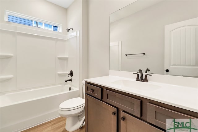 full bathroom featuring toilet, hardwood / wood-style floors, vanity, and shower / washtub combination