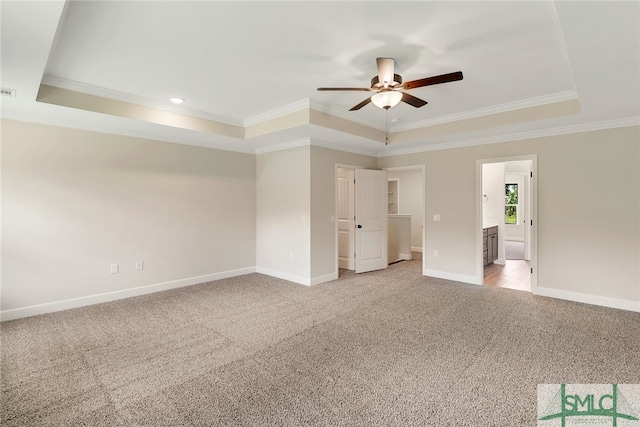 unfurnished room featuring ceiling fan, light carpet, and a tray ceiling