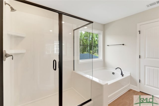 bathroom featuring wood-type flooring and independent shower and bath