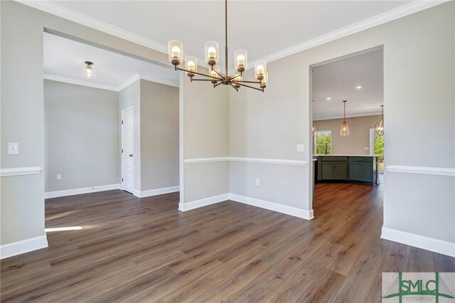51 Hanover Pl, Richmond Hill, GA 31324 - unfurnished dining area with crown molding, a chandelier, wood finished floors, and baseboards