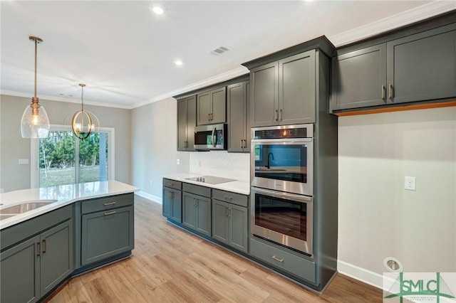 51 Hanover Pl, Richmond Hill, GA 31324 - kitchen featuring stainless steel appliances, visible vents, a chandelier, light countertops, and light wood-type flooring