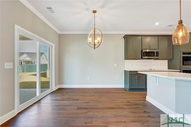 51 Hanover Pl, Richmond Hill, GA 31324 - kitchen with appliances with stainless steel finishes, gray cabinets, decorative backsplash, and ornamental molding