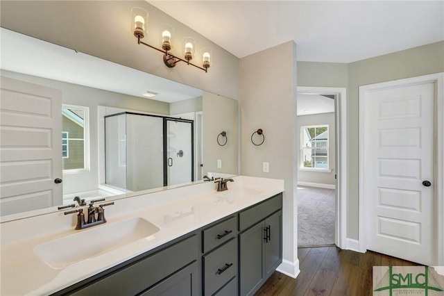 51 Hanover Pl, Richmond Hill, GA 31324 - full bath featuring a stall shower, double vanity, a sink, and wood finished floors