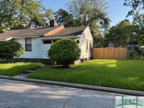 view of side of home featuring a yard