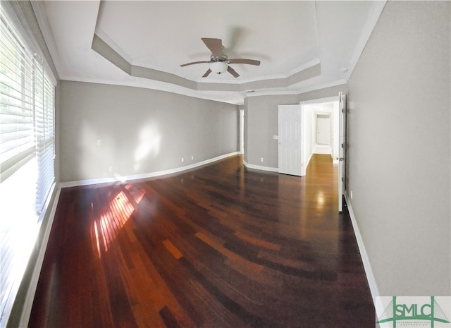 unfurnished room with ceiling fan, crown molding, a tray ceiling, and hardwood / wood-style floors