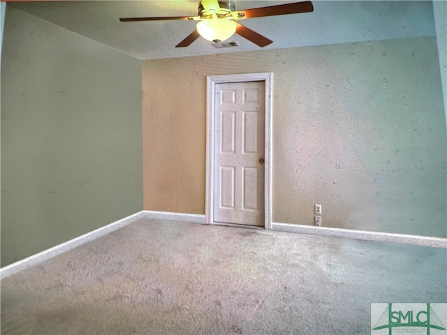 spare room with carpet flooring and ceiling fan