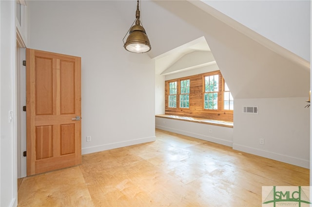 bonus room featuring lofted ceiling, visible vents, and baseboards