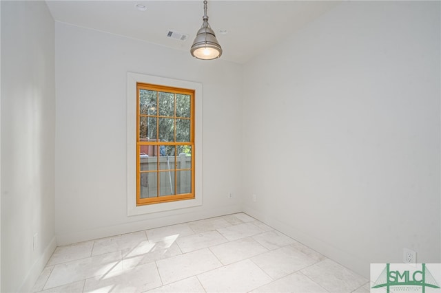 unfurnished room featuring visible vents and baseboards