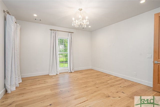 spare room featuring baseboards, light wood-type flooring, and recessed lighting