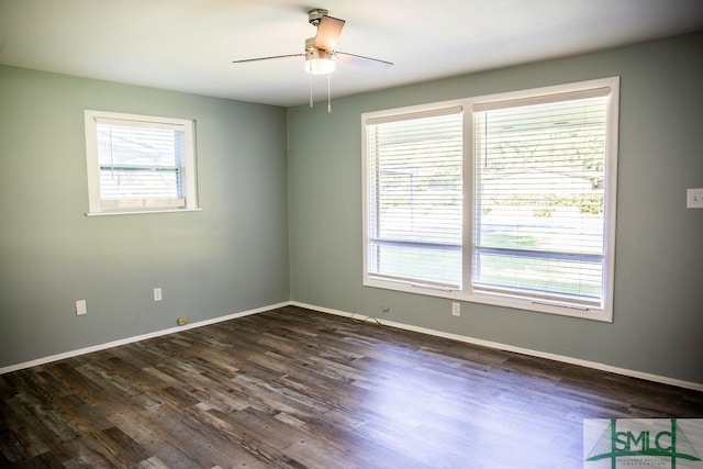 empty room with dark hardwood / wood-style flooring and ceiling fan