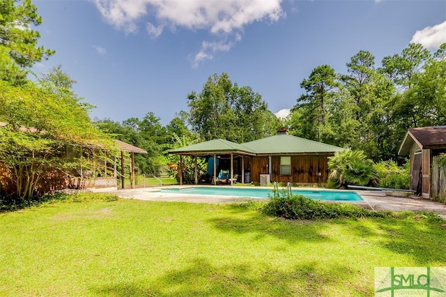 rear view of property featuring a lawn