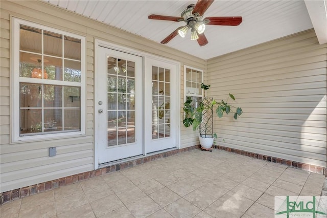 unfurnished sunroom with ceiling fan