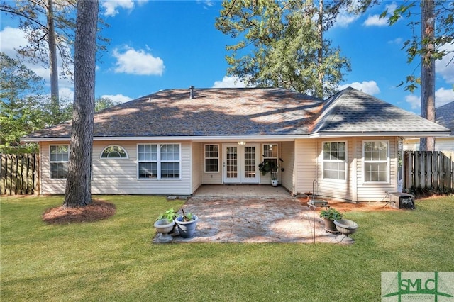 back of house with a lawn, a patio, and french doors